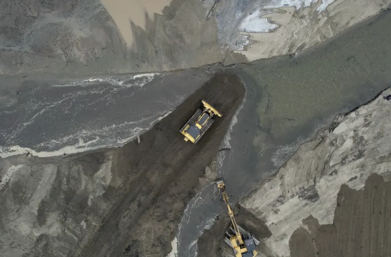 Drone image of Paradise Pond work with a yellow bulldozer and excavator moving silt